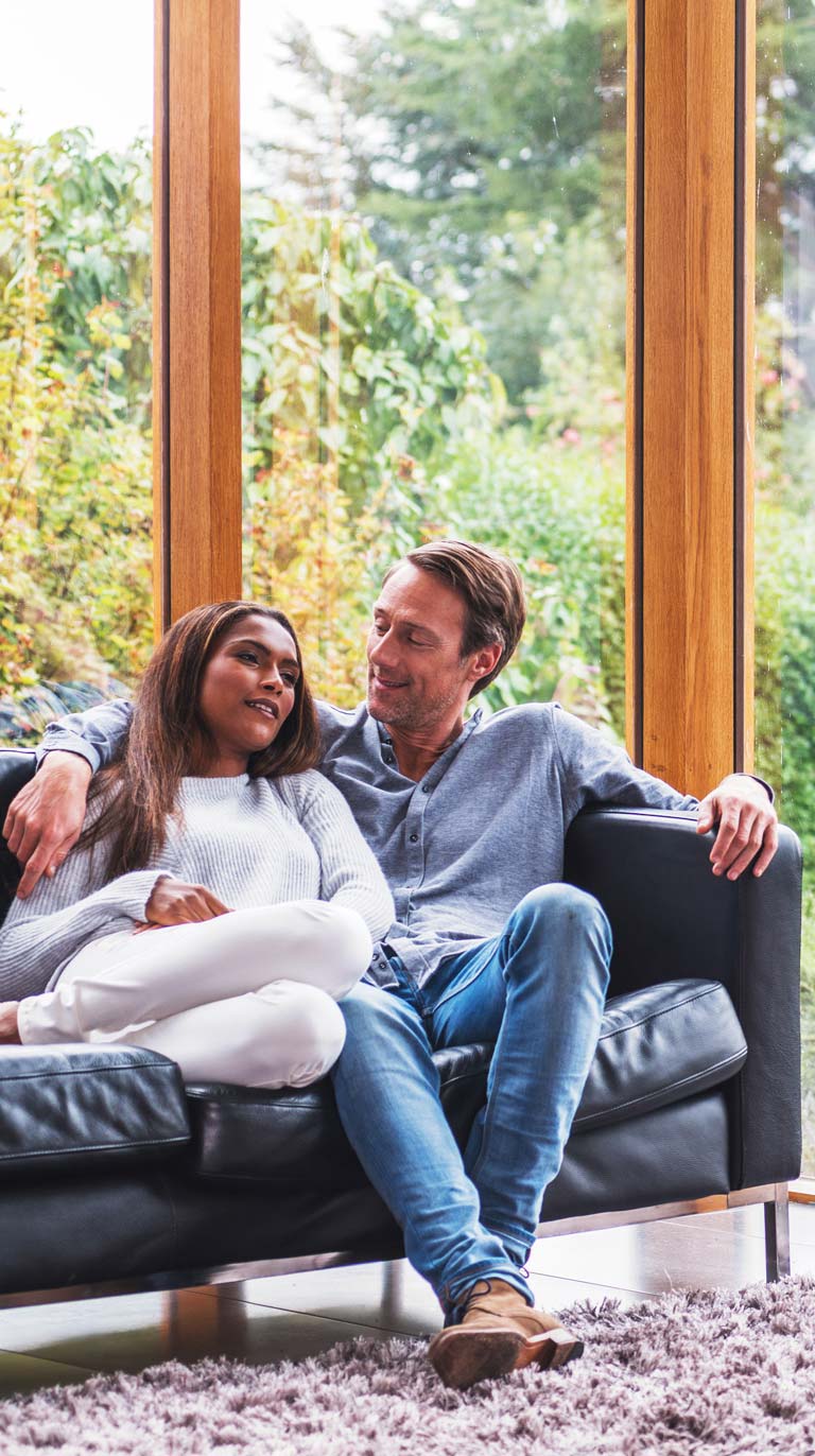 couple sitting on black couch