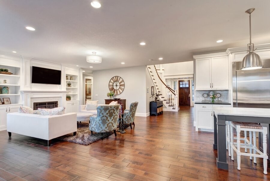 An open living space featuring overhead smart lighting fixtures.