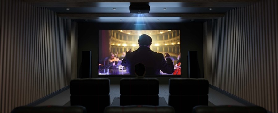 A luxury home theater with a composer on the screen.