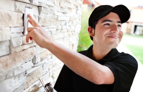 Service man ringing doorbell of a home equipped with an access control system.