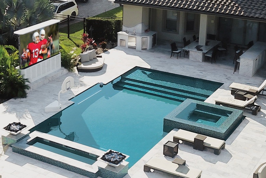 A Stealth Acoustics TV installed on a pool deck of a luxury home. 