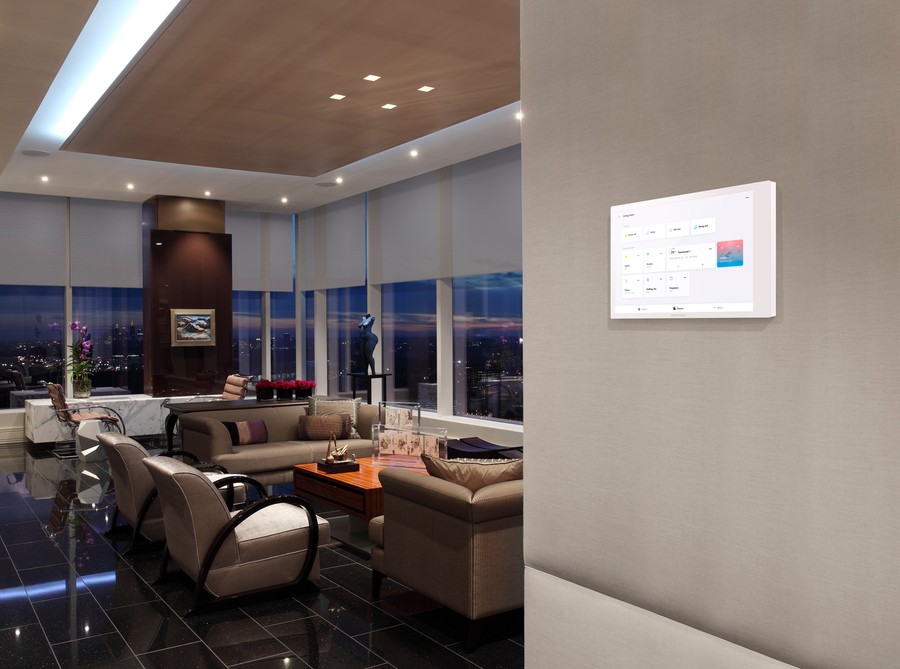 View of a living room featuring a wall-mounted Crestron smart interface.