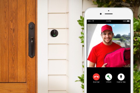 Close-up image of a video doorbell and a smartphone interface showing a delivery person 